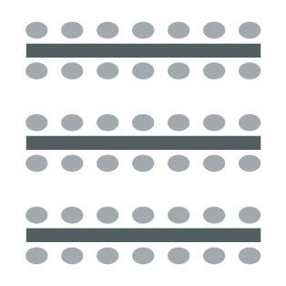 Chairs placed at tables in long rows