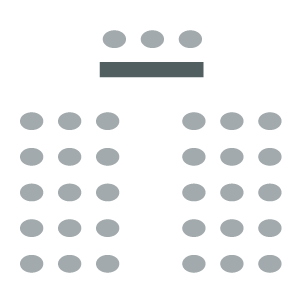 Chairs placed in rows facing a front table with chairs for presenters