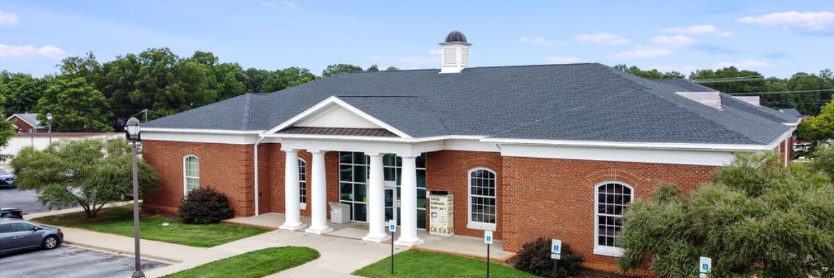 Aerial shot of Powdersville Library building front featuring brick, columns, plinth, and cupola