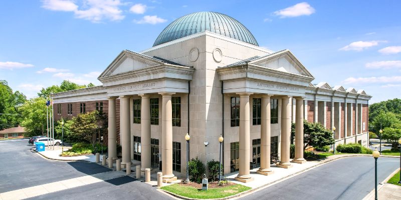 Anderson County Main Library roofline featuring columns, pediments, and dome