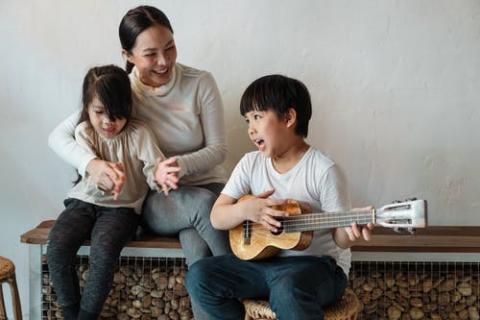 Family having engaging and having fun with singing as an early literacy tip.