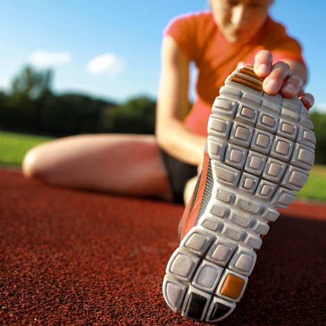 photo of person stretching with walking shoes on