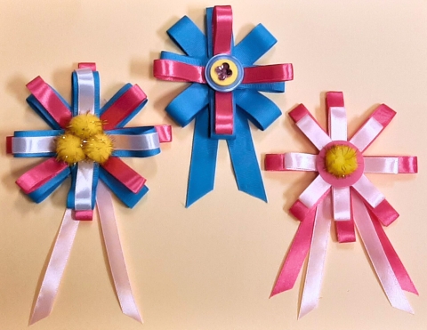 three handmade pink and blue ribbons.