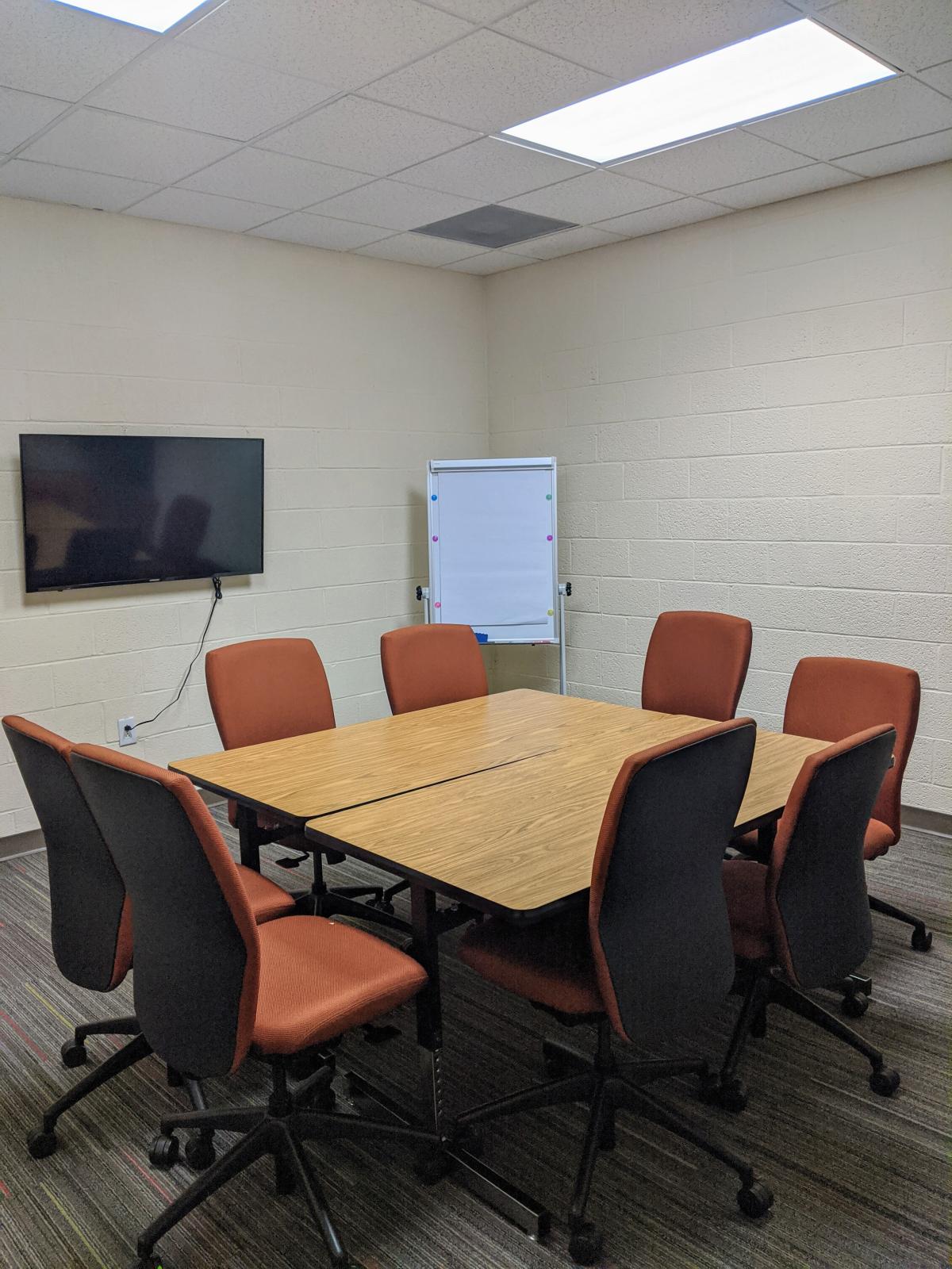 Westside Community Center Library Meeting Room image showing tables pushed together to form central conference table