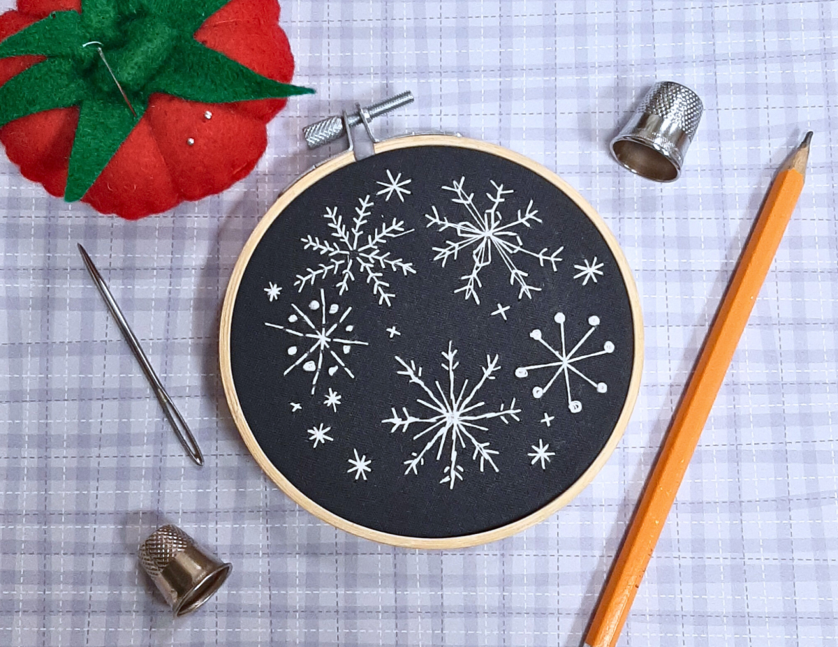 snowflake patterned embroidered on dark fabric 