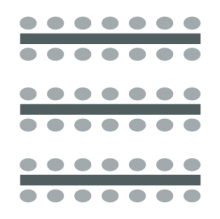 Chairs placed at tables in long rows